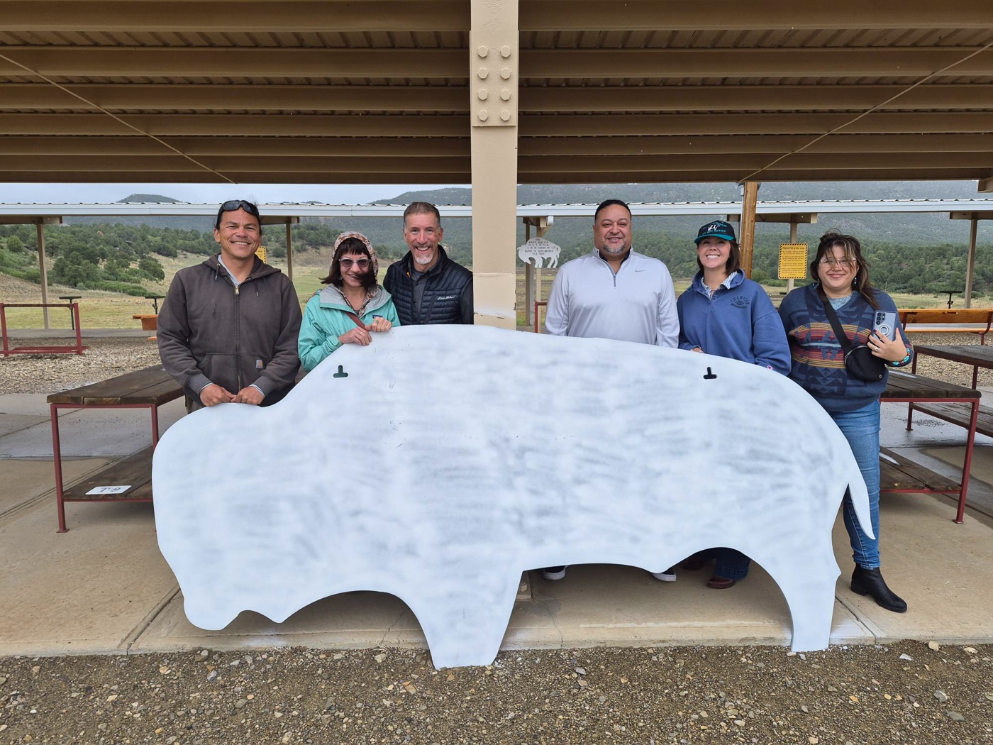 shooters posing with the white buffalo target during a range day with no guns visible